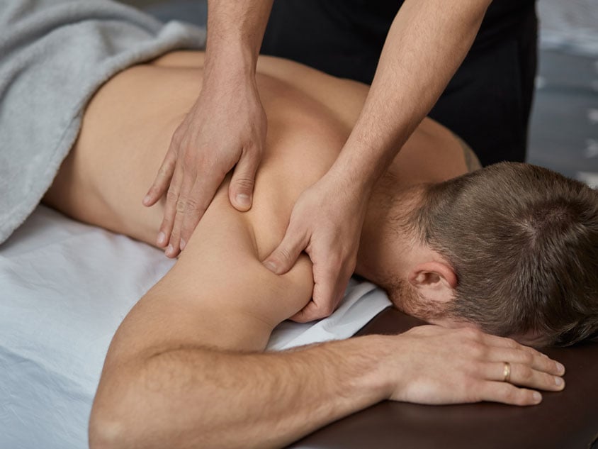A woman receiving a back massage